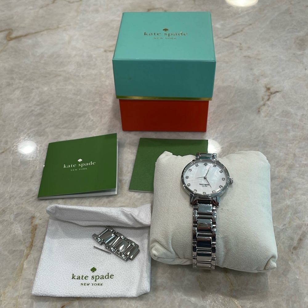 Kate Spade wrist watch.  Silver/mother of pearl face with diamonds.
